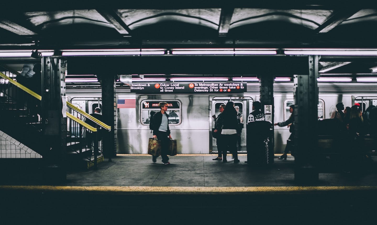 Man walking in between subway platforms