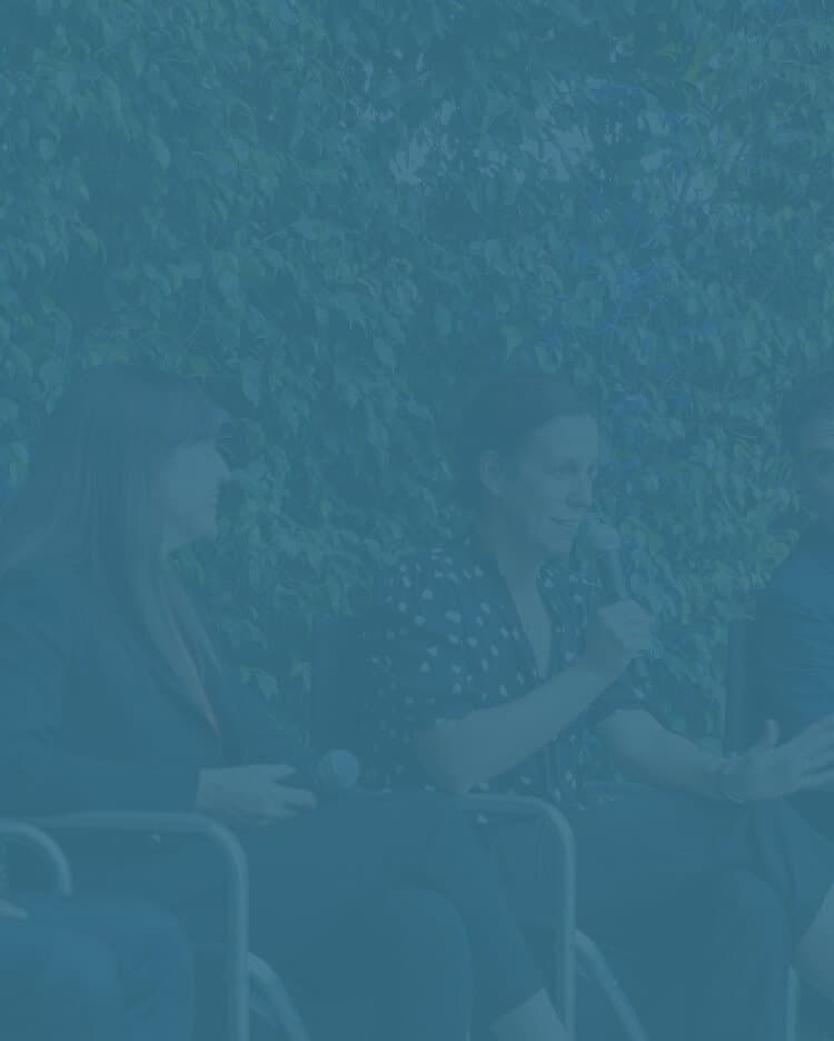 a group of people sitting next to each other speaking for a panel